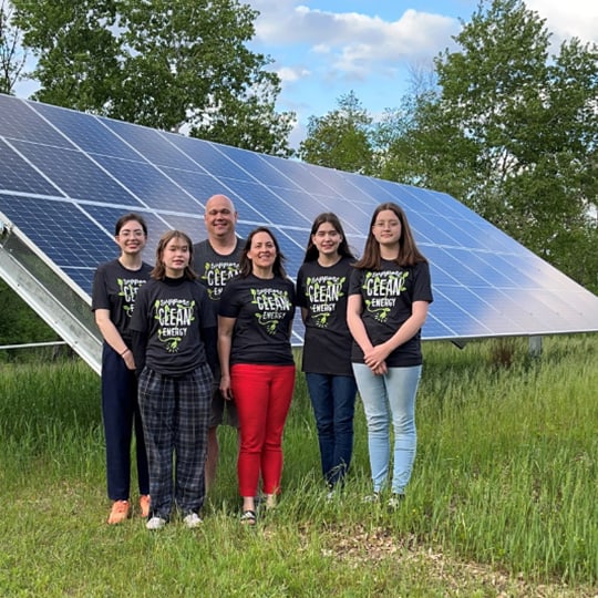 teens in front of solar in field